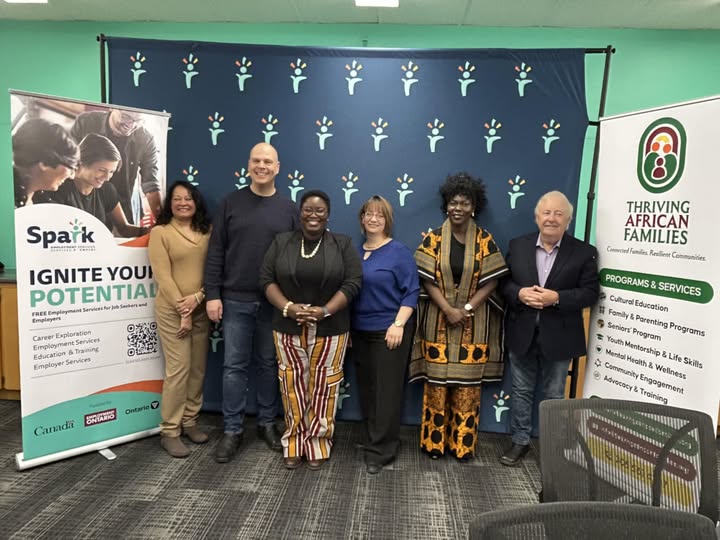 People standing in front of a blue banner