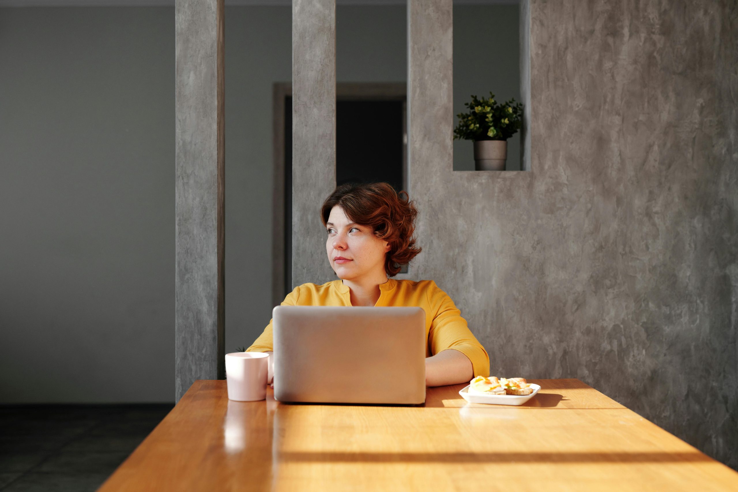woman working alone laptop thinking